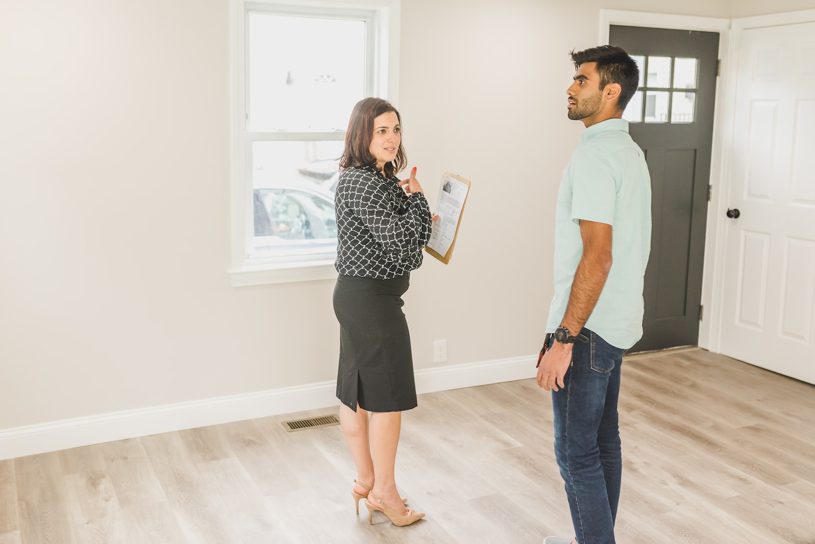 Man Checking on a House with a Real Estate Agent